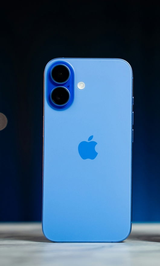 Two iphones sitting side by side on a table